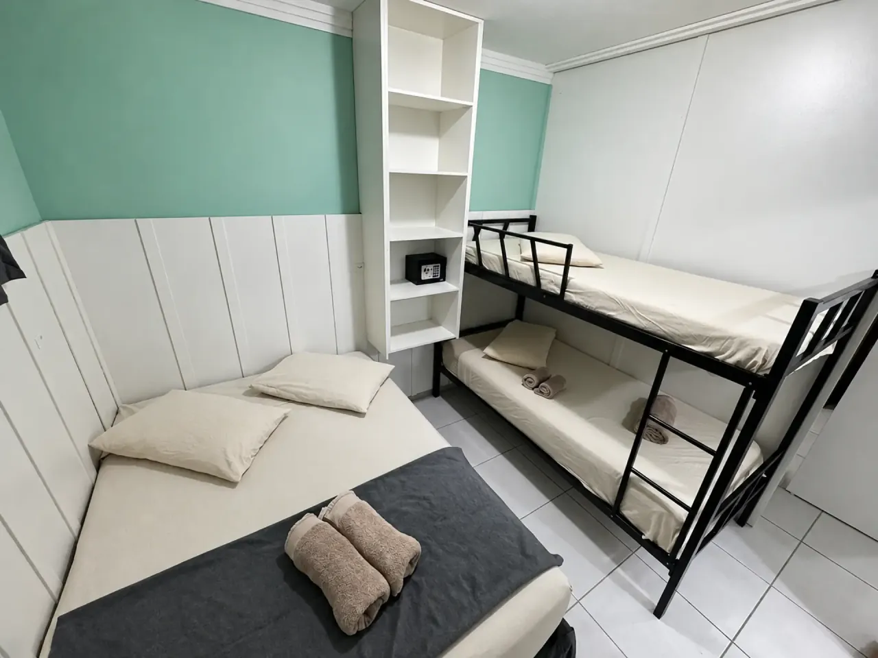 Guest room with a double bed and bunk beds
