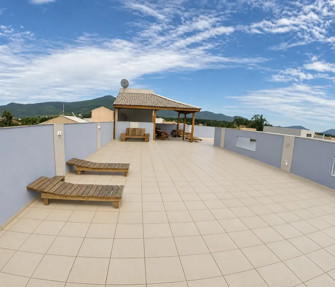 Rooftop terrace with loungers and a covered seating area