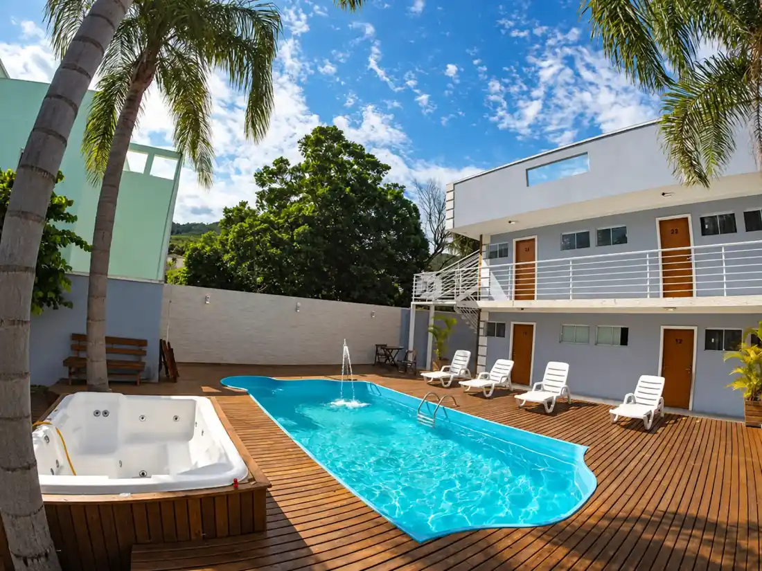 Outdoor hot tub beside the pool on the wooden deck