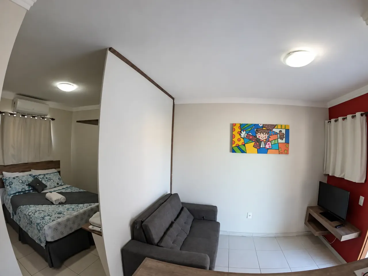 Triple Room with double bed, sofa and television