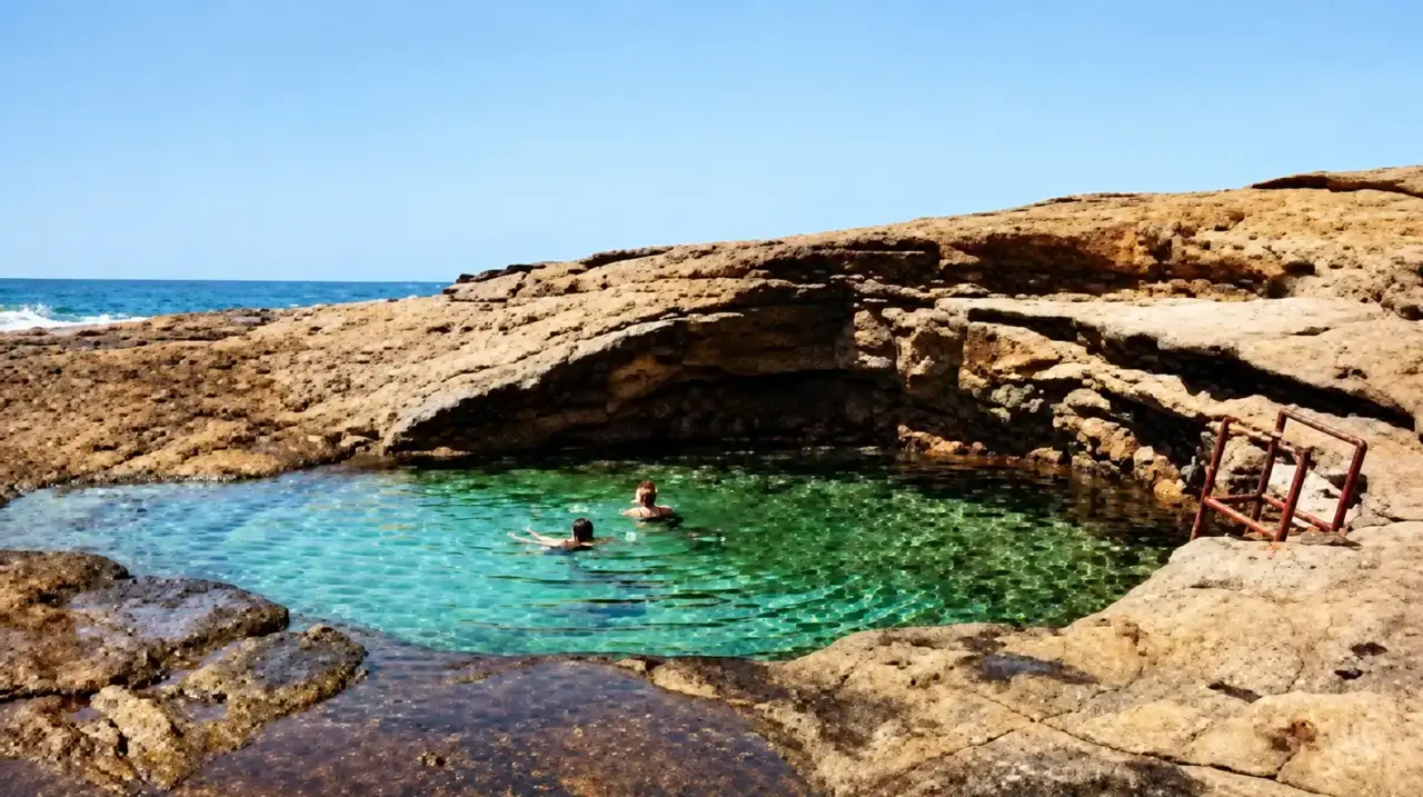 Swimmers in a natural rock pool on the Barra da Lagoa coast