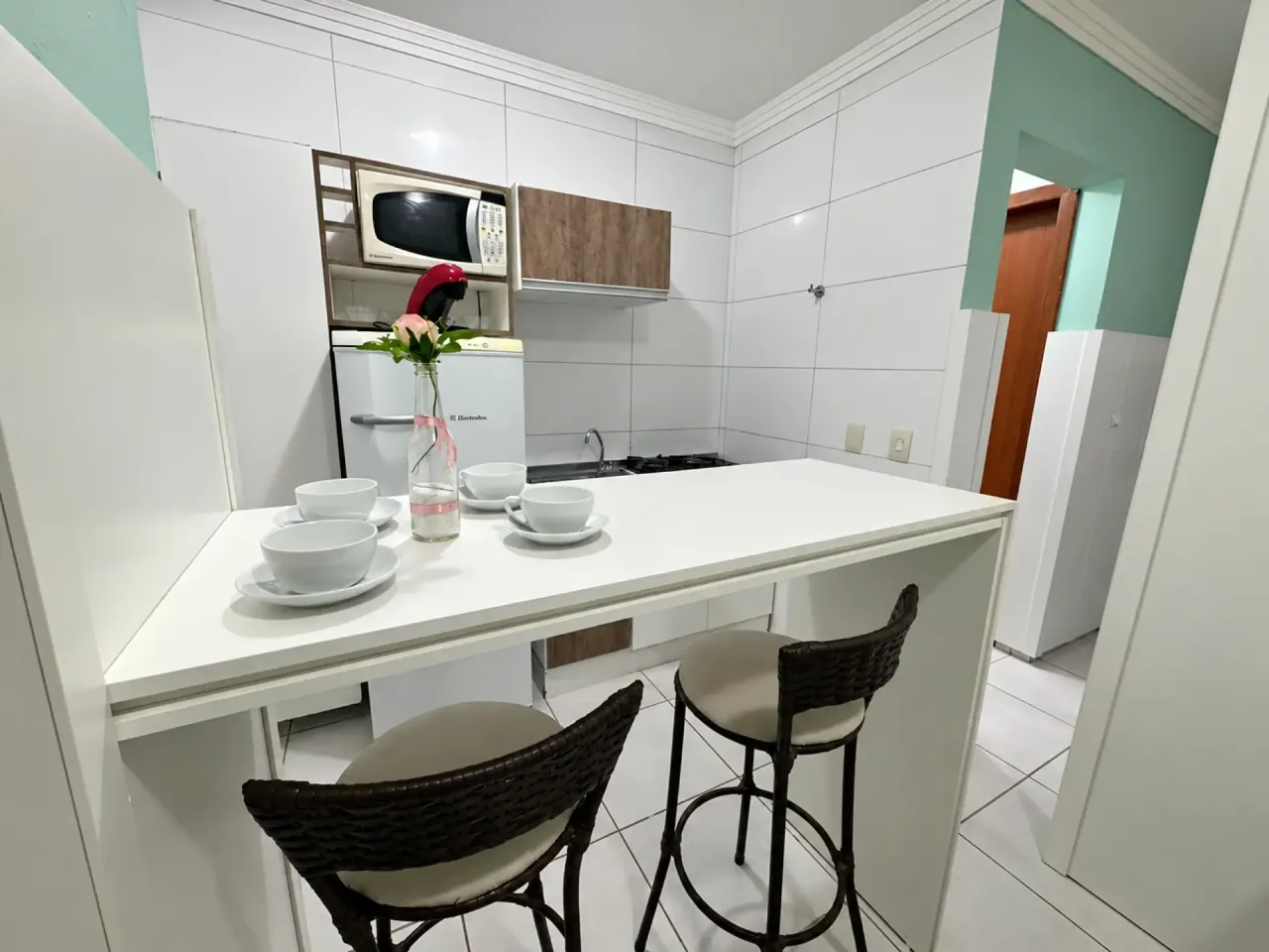 Guest kitchen with counter, stools and microwave